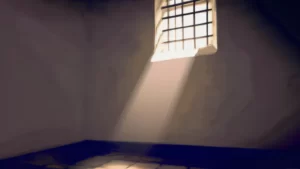 inside of a jail cell with light coming in through the window