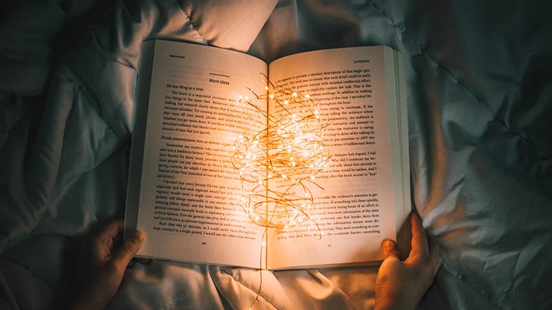 open book with light shining in the middle