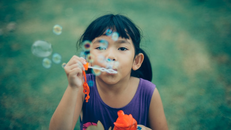 joy child blowing bubbles