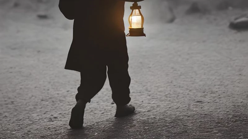 man carrying lantern