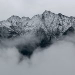 mountain peaks seen through gray clouds