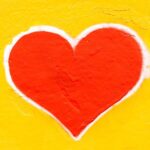 red heart on yellow background painted