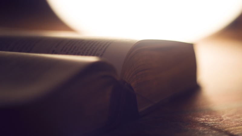 bible open with a bright light in the background