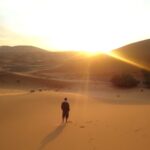 man standing in the desert in the morning