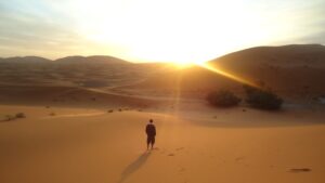 man standing in the desert in the morning