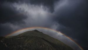 Rainbow over a green mountain