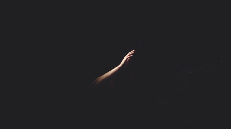 hand reaching out in the darkness