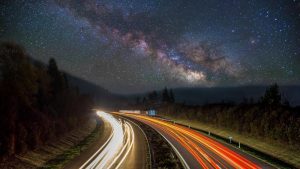 road with lights in a valley at night