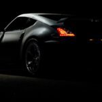sports car with tail lights on in dark