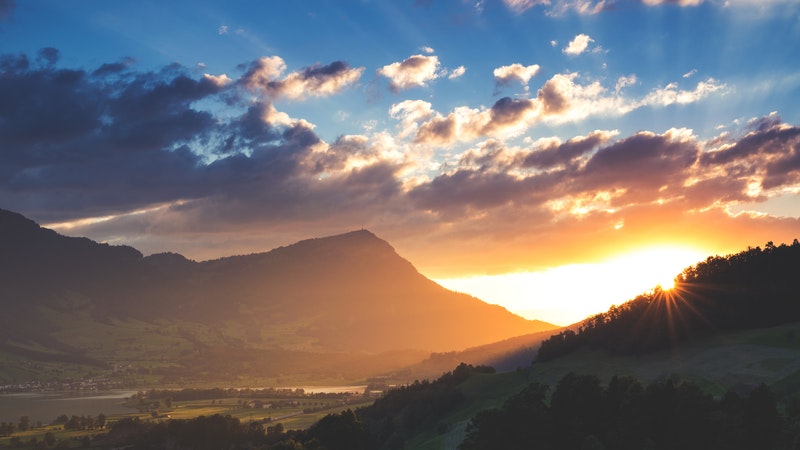 sun rising in a mountain valley