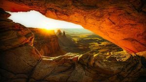 view of sunrise through the opening of a cave