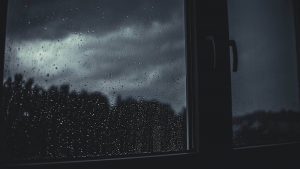 a dark rainy day seen through a window